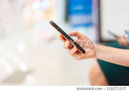 Portrait of hand holding mobile phones. Person is playing and touch screen telephone. Telephone is a modern communication technology. 118271237