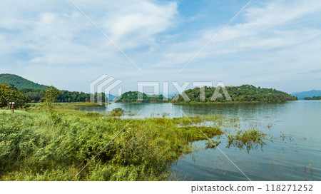 Kaeng Krachan dam with lake view and many green moutain, blue sky background. Kaeng Krachan Dam national park, Phetchaburi province, Thailand in aerial view from drone. Kaeng Krachan dam with lake view and many green moutain, blue sky background. Kaeng Krachan Dam national park, Phetchaburi province, Thailand in aerial view from drone. 118271252