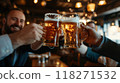 Group of men in business suits raising their glasses of beer, smiling and clinking glasses to celebrate successfully completed project, deal. 118271532