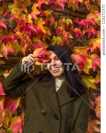 Stylish Woman in Autumn Foliage 118272375