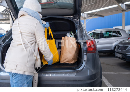 Woman uploading Groceries into Car 118272444