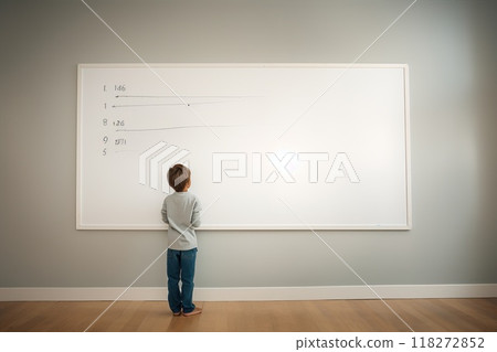 A young child is actively engaged in a math activity while using a whiteboard.  118272852