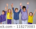 group of cheerful children pulled his hands up in white wall 118273083
