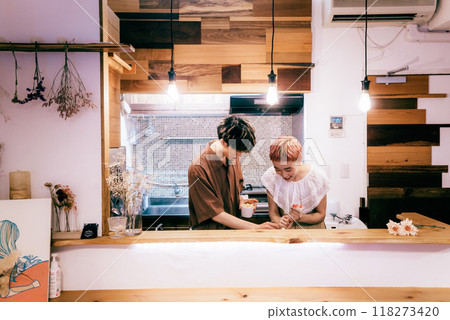 Couple making a cake in the kitchen 118273420