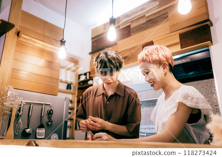 Couple making a cake in the kitchen 118273424