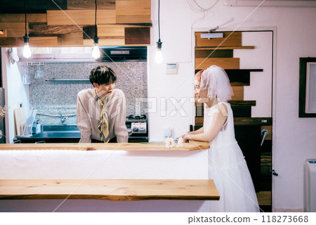 Bride and groom chatting in the kitchen Bride and groom chatting in the kitchen 118273668