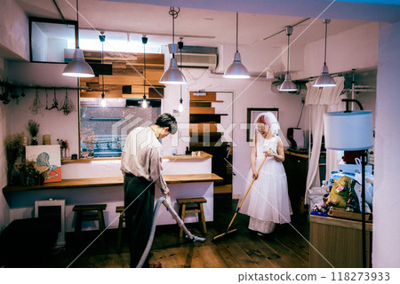 Newlywed couple vacuuming 118273933