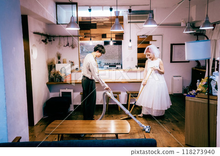 Newlywed couple vacuuming 118273940