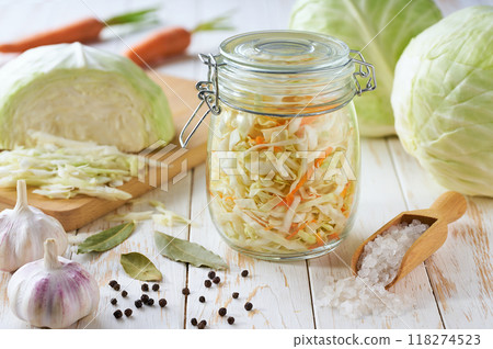 preparation for making sauerkraut or fermented white cabbage with carrot. Food fermentation. Fermented preserved vegetarian food. preparation for making sauerkraut or fermented white cabbage with carrot. Food fermentation. Fermented preserved vegetarian food. 118274523
