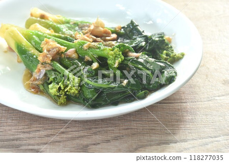 fried Kailaan Chinese kale dressing oyster sauce with chop garlic on plate 118277035