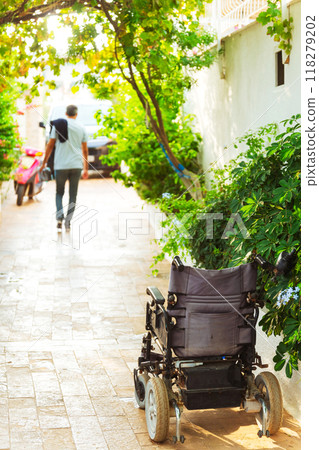 wheelchair parked directly on the garden path.  118279202