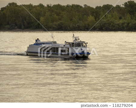 A river passenger vessel with a water jet engine sailing along the river A river passenger vessel with a water jet engine sailing along the river 118279204