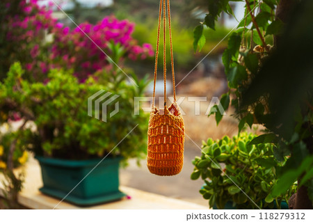 garden lantern wicker made of ropes and glass jar suspended in the garden garden lantern wicker made of ropes and glass jar suspended in the garden 118279312