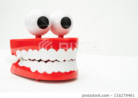 Tooth funny toy denture red color jaw and eye on white background with copy space. 118279461