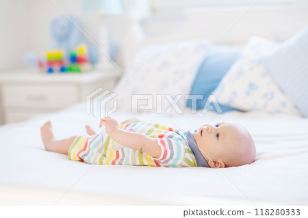 Little baby on white bed Little baby on white bed 118280333