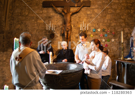 Baptism of newborn baby in Catholic church. 118280363