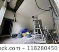 Renovation room with ladder and exposed electrical wires 118280450