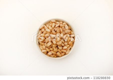 Pine nuts on a white plate. Hazelnuts. Pine nuts on a white plate. Hazelnuts. 118280830