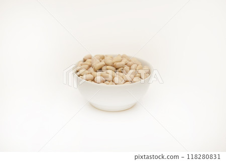 Pine nuts on a white plate. Hazelnuts. Pine nuts on a white plate. Hazelnuts. 118280831