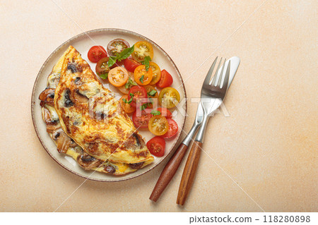 Delicious meal with omelette with mushrooms and cherry tomatoes served on plate, healthy breakfast top view, space for text Delicious meal with omelette with mushrooms and cherry tomatoes served on plate, healthy breakfast top view, space for text 118280898