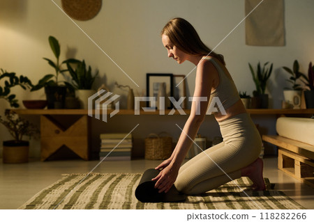 Unrolling mat before fitness training Unrolling mat before fitness training 118282266