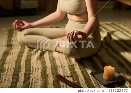 Woman practicing yoga on the floor 118282272