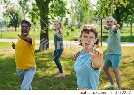 Stretching arm forwards during exercise Stretching arm forwards during exercise 118282297