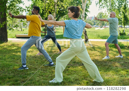 Trainer showing new exercise to people Trainer showing new exercise to people 118282298