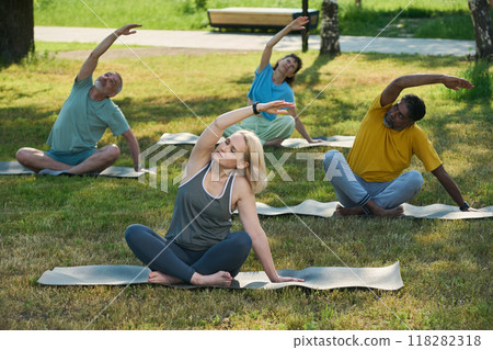 Active people doing side bends on mats 118282318