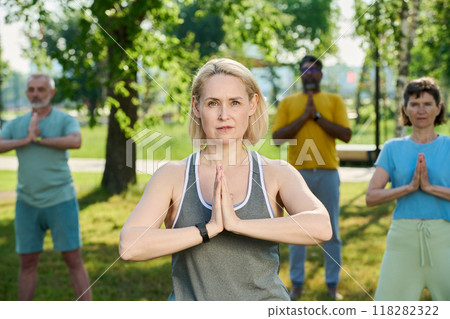 Woman with hands put together by chest Woman with hands put together by chest 118282322