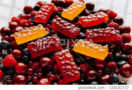 Colorful natural berry marmalade on fresh mixed fruits and berries, healthy sweet indulgence Colorful natural berry marmalade on fresh mixed fruits and berries, healthy sweet indulgence 118282727