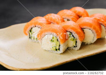 Philadelphia salmon sushi rolls with creamy filling, perfect for Japanese cuisine lovers Philadelphia salmon sushi rolls with creamy filling, perfect for Japanese cuisine lovers 118282732