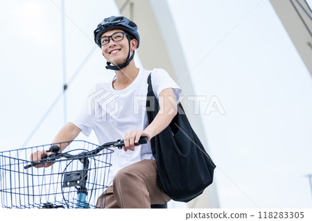A man riding a bicycle 118283305