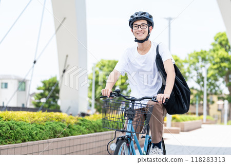 A man riding a bicycle A man riding a bicycle 118283313