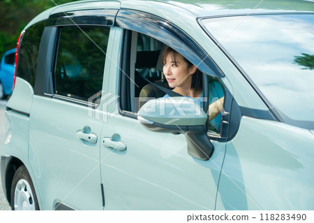 A woman driving a car A woman going for a drive A woman driving a car A woman going for a drive 118283490