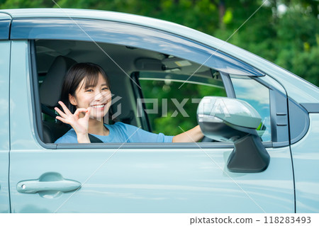 A woman driving a car A woman going for a drive A woman driving a car A woman going for a drive 118283493