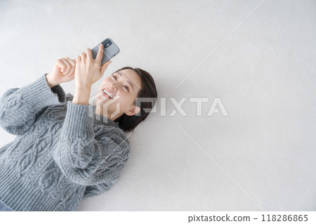 Woman relaxing in the living room Woman relaxing in the living room 118286865