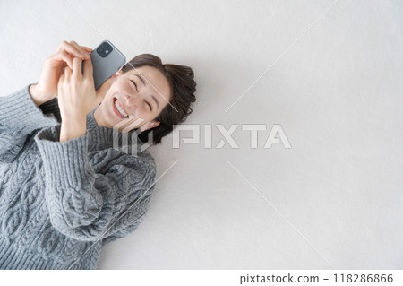 Woman relaxing in the living room Woman relaxing in the living room 118286866