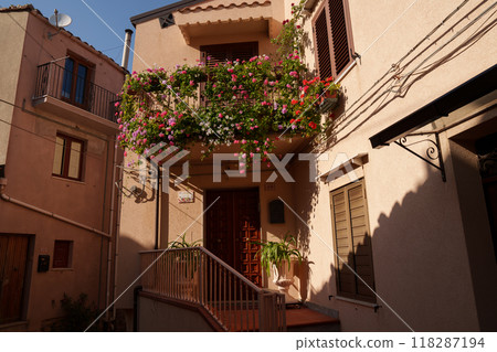 Flower-adorned balcony on charming Mediterranean village house 118287194