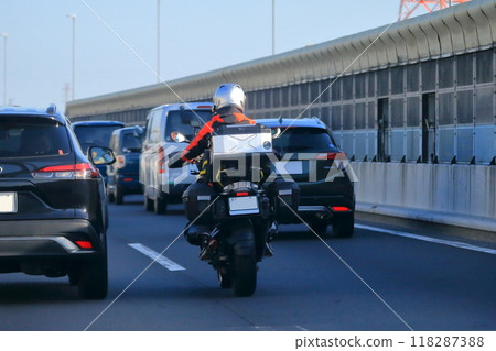 Motorcycle traveling on the highway 118287388