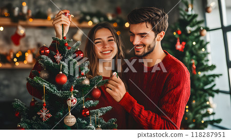 Young couple decorating Christmas tree together 118287951