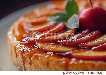 Indulge in a beautifully crafted apple Tarte Tatin with sweet red apples, perfect for a cozy evening dessert 118288680