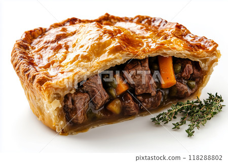 Deliciously cut open steak and kidney pie showcasing tender meat and vibrant vegetables on a pristine white plate 118288802