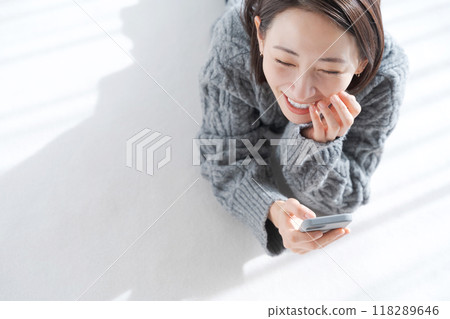 Woman lying on the living room floor Woman lying on the living room floor 118289646