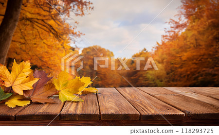 Wooden base and autumn leaves 118293725