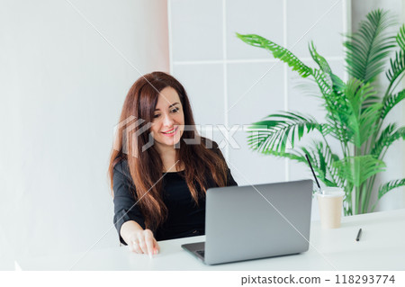 Business woman brunette working online laptop from home Business woman brunette working online laptop from home 118293774