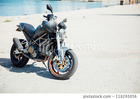Black sports motorcycle parked in the parking lot 118293856