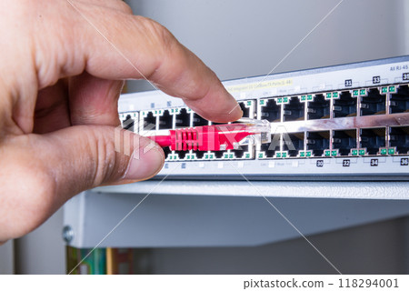hand with red ethernet cable 118294001