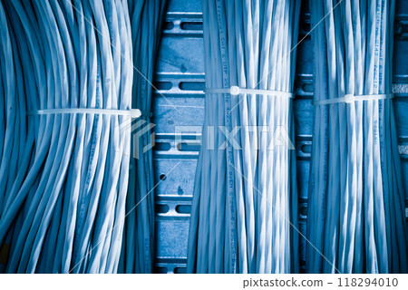 bunch of network cables in wave pattern leading across server ro 118294010
