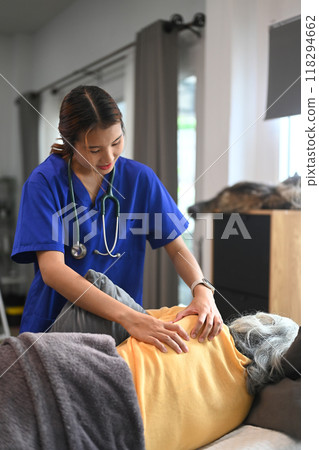 Physiotherapist doing shoulder blade therapy on mature patient. Physical therapy and rehabilitation concept Physiotherapist doing shoulder blade therapy on mature patient. Physical therapy and rehabilitation concept 118294662